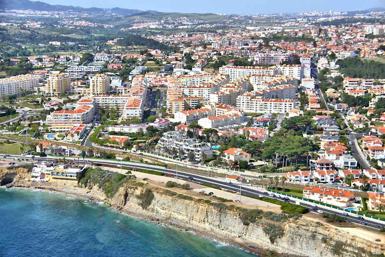 Flying almost due west along the coastline from west Lisbon, we see the coastal towns (and the cliffs) of Estoril and Cascais, before coming to the cliffs on the coast of the Sintra National Park.