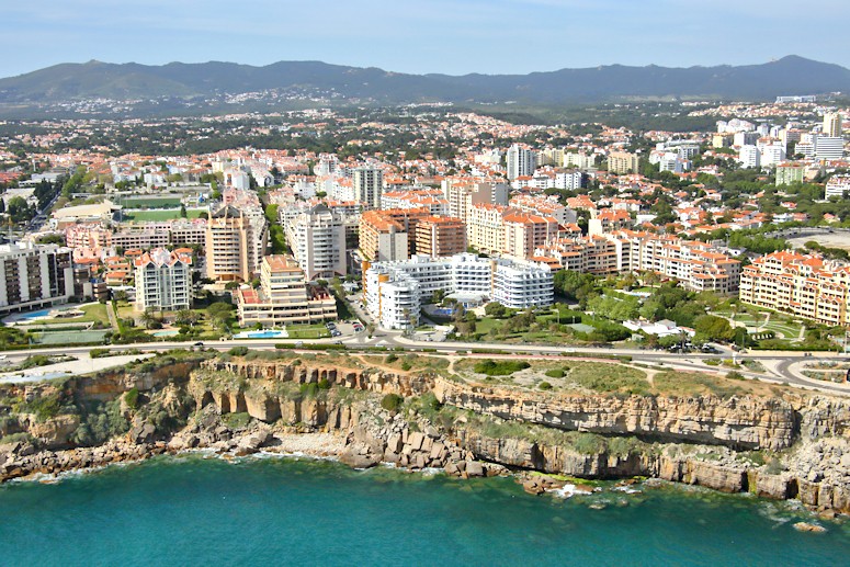 Flying almost due west along the coastline from west Lisbon, we see the coastal towns (and the cliffs) of Estoril and Cascais, before coming to the cliffs on the coast of the Sintra National Park.