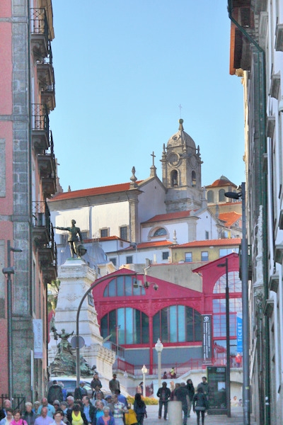 In the old town we see the Statue of Infante dom Henrique (Prince Henry the Navigator) -  in the background the Market-Hall Ferreira Borges - Porto, Portugal