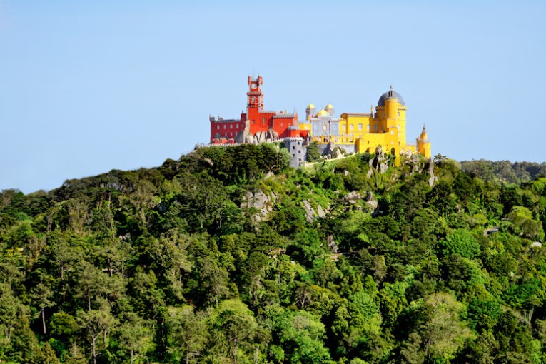 Approaching the Pena Palace in the Sintra hills by air. It is a Romanticist castle built in 1836 AD in Sintra, Portugal.